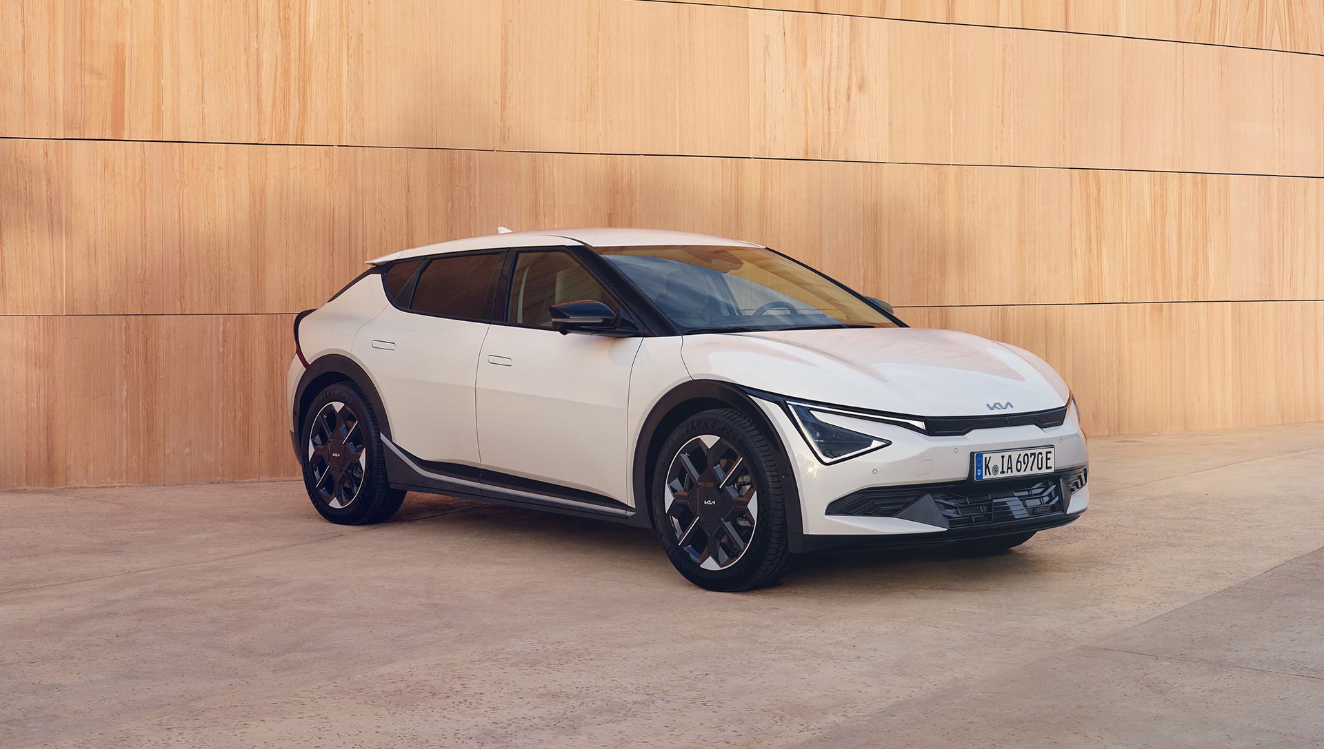 Side view of Kia EV6 parked beside a wall.